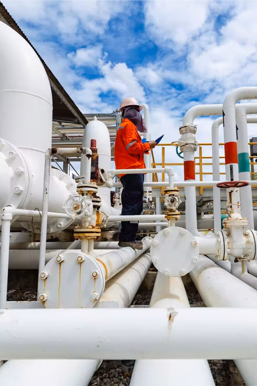 Worker standing on pipeline
